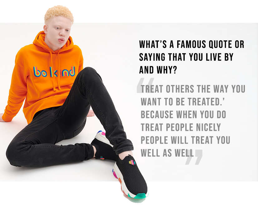 Shem modelling the orange Be Kind Hoodie